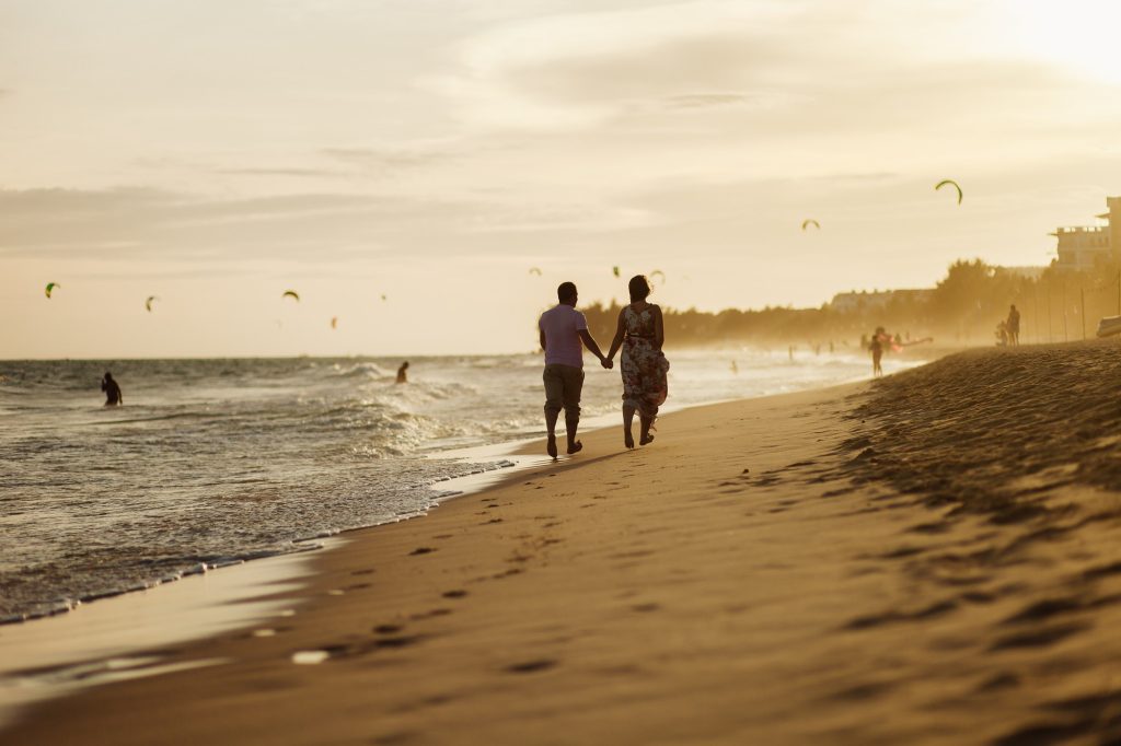happy couple run on beach